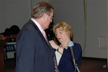 First Lady Beth Saunders pinning her husband Kentucky State President Vernon(Skip) Saunders. 
