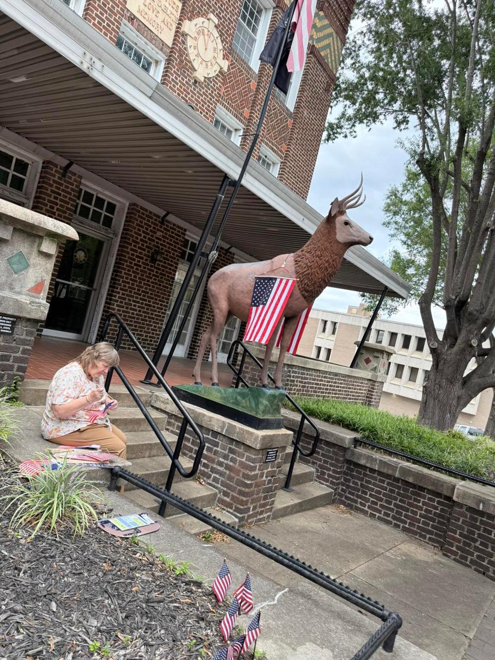 member Carla helping with the flags