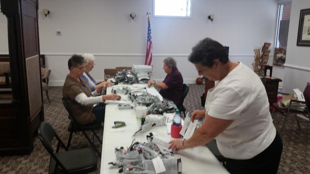 Sandra Angel, Mary Markham, Gail St Clair and Molly Croft preparing safety glasses for delivery to county Shop and Ag classes