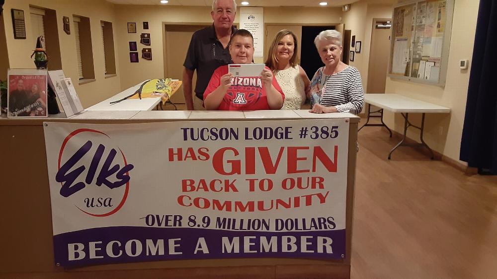 On October 22, 2024, Tucson Elks Lodge #385 once again donated, this time, an Apple Watch to the local Tucson AZ Prader-Willi Syndrome Association for their National Convention silent auction. Pictured L-R: Trustee/PER Wayne Burns, Tammie Penta and her son and Lois Wilford.  