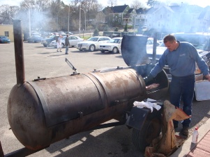 Pictured is Master Pig Chef Troy cooking the 110 pound pig. 