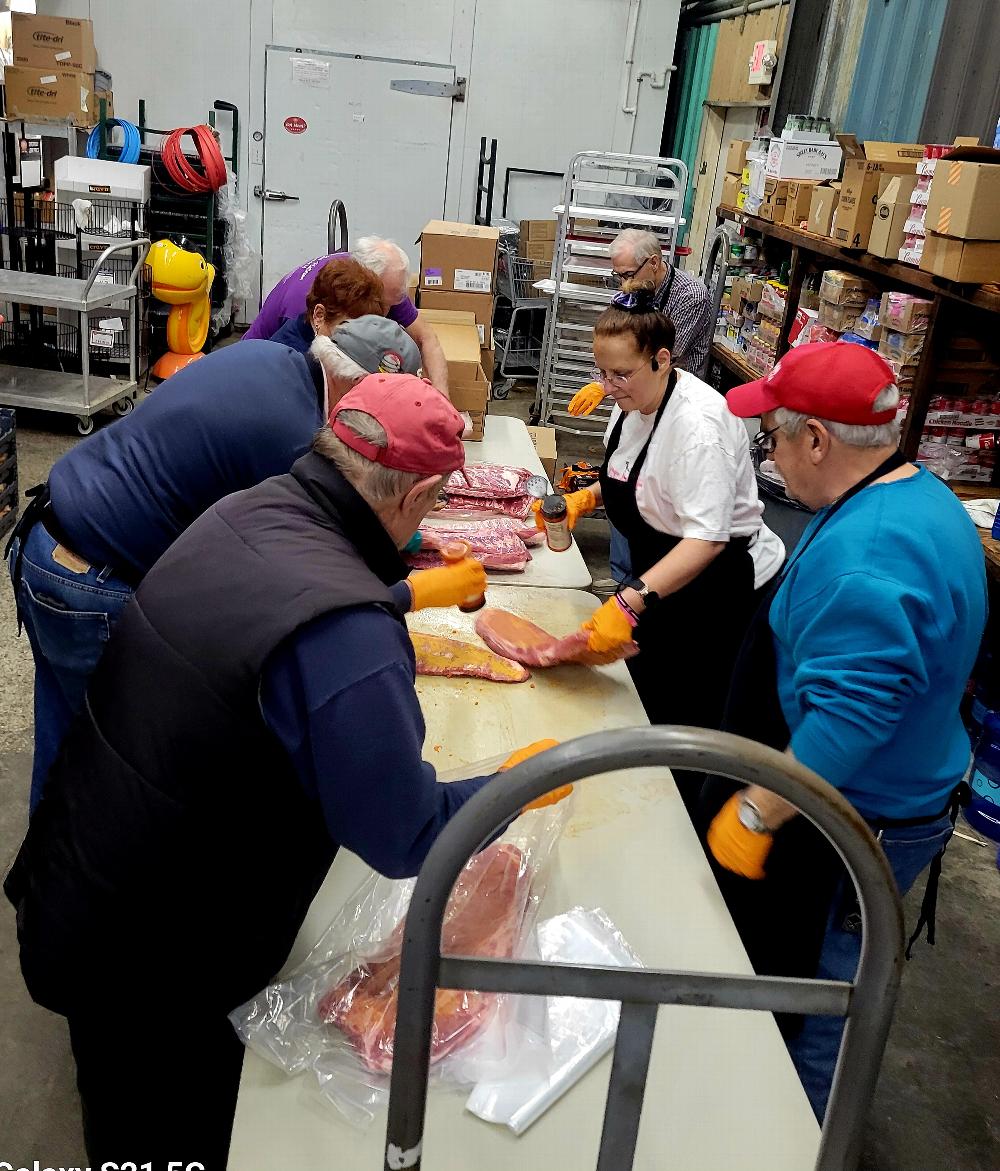 Guy Pascarella and an unidentified gentleman on the lamb from his ex-wives repack the ribs for grilling