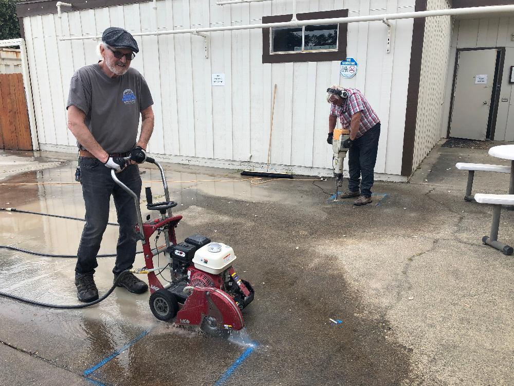 "Wrecking Crew" Rex Crabtree cutting the concrete & Ken Rieke jack hammering the concrete to prepare for building new poolside shade structures