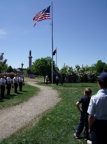 The American Flag is raised from half staff during services on Memorial Day  at the Rochester Commons.