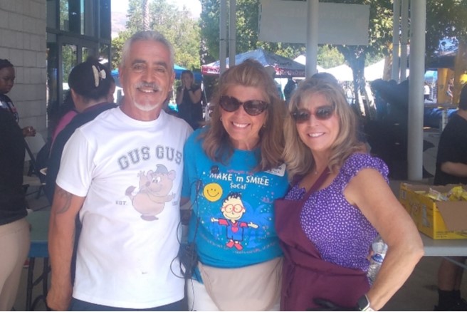 Photo of Shelly and Jess Gonzales with reginal director of Make m Smile where 900 hungry people were fed by elite Elks Lodge members.