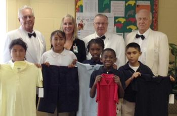 $2000.00 Grant from the Elks National Foundation allowed us to purchase and distribute 100 school
uniforms to children in need at the Manatee  Elementary School. Pictured below are some of the students with the new uniforms. In the rear, left to right is Roger Marx, Lecturing Knight, Dr. Faulkenburg, Councilor, Ray Honan, Exalted Ruler and Gene Stillwell, Leading Knight.
