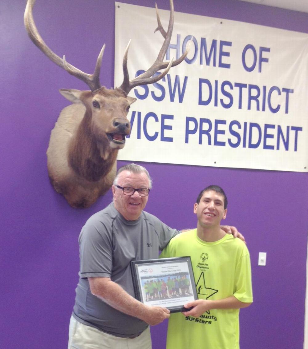 Michael Dangler, son of Stephanie & Douglas Dangler, Naples Elks Lodge #2010 members, presented a plaque to the Lodge for our annual sponsorship of the Naples Special Olympics. The plaque pictures the participants of the 2016 Stand Up Paddle fund raising event. The Lodge donated $250 toward this event. Accepting the plaque for the Lodge is the Lodge Secretary, Ray Honan, PER