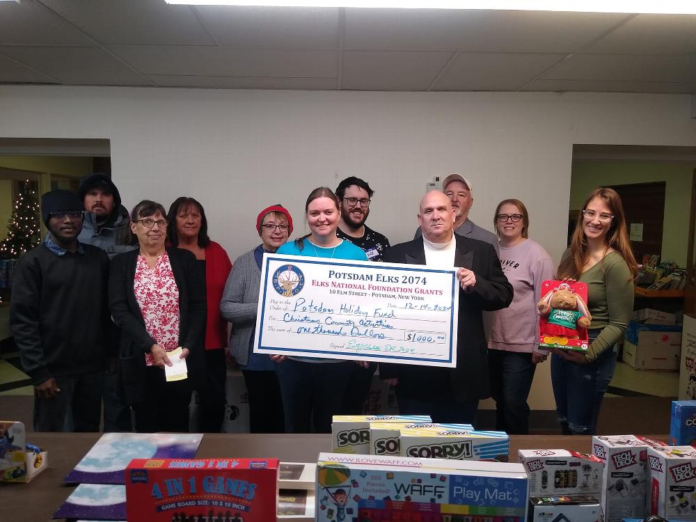 Potsdam Lodge #2074  supported the Potsdam Holiday Fund with a $1,000 donation. The Lodge used proceeds from an Elks National Foundation Gratitude Grant to support the donation. Exalted Ruler Ernie Charleston and Inner Guard Steve Myers are pictured presenting the donation on behalf of the Lodge to Potsdam Holiday Fund President Staci Giffin and Holiday Fund volunteers.