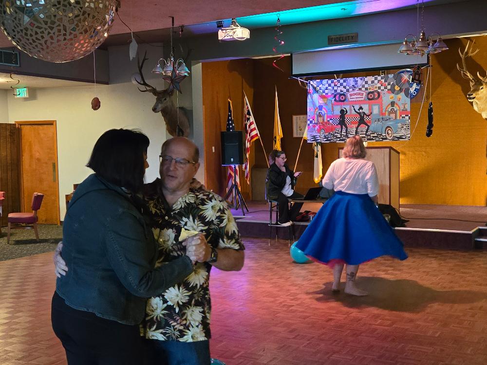 Greg and Shirley dance to the 50s Rock and Roll while Jennifer takes her poodle skirt across the dance floor.