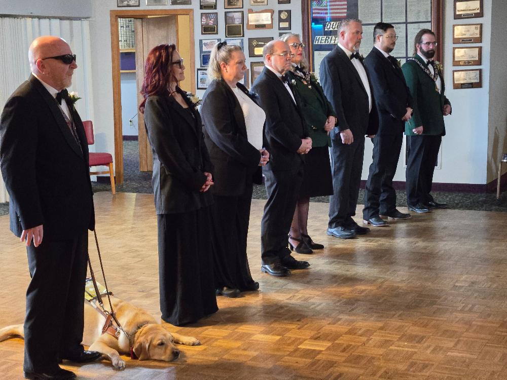 The lodge officers prepare for installation, from left to right: Norm Jones, Inner Guard; Tammie Johnson, Chaplain; Sue Lemaster, One-Year Trustee; Greg Clark, Treasurer; Jennifer Braibish, Secretary; and Rob Turkisher, Esteemed Leading Knight. Past Exalted Ruler Jerry Sheehan, far right, served as Esquire for the ceremony.