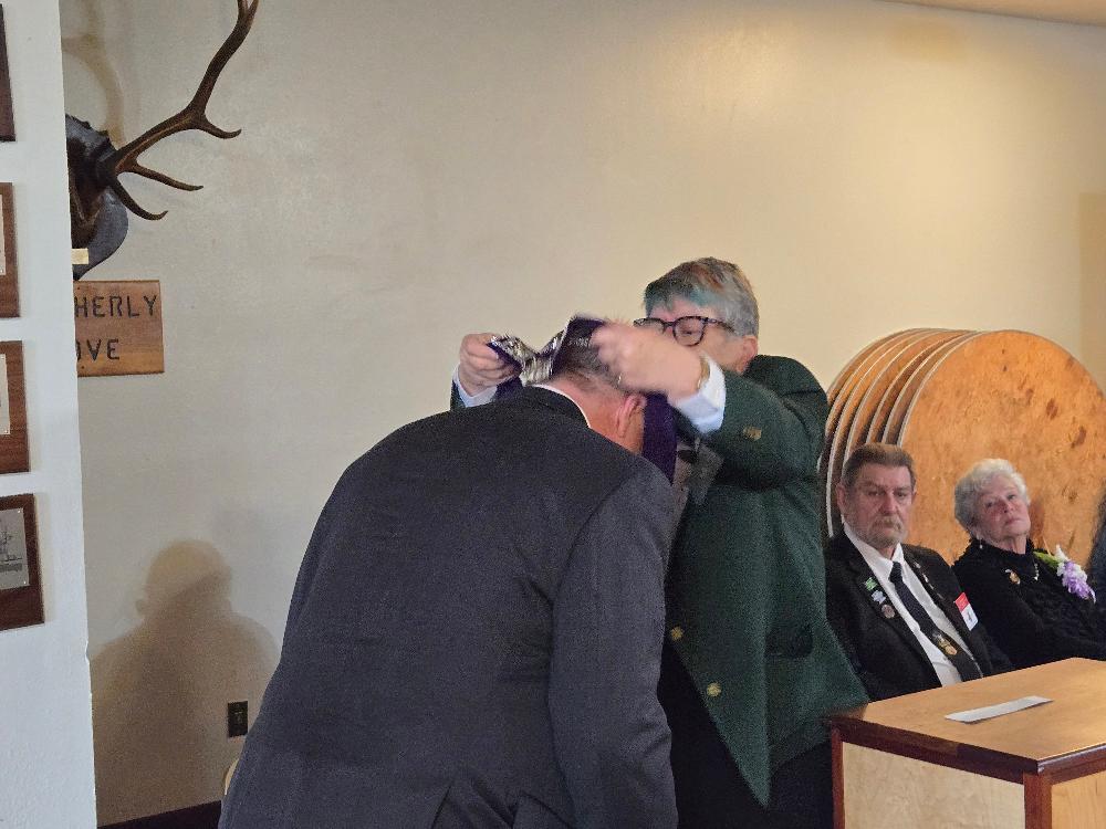 Past Exalted Ruler Kay Jones installs Rob Turkisher as Esteemed Lecturing Knight.