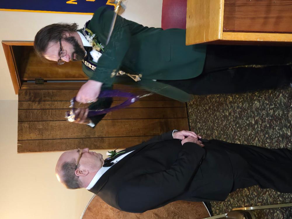 Past Exalted Ruler Jerry Sheehan installs Greg Clark as Treasurer.