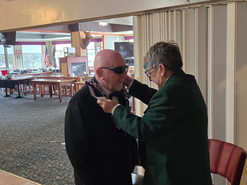 Past Exalted Ruler Kay Jones installs Norm Jones as Inner Guard.