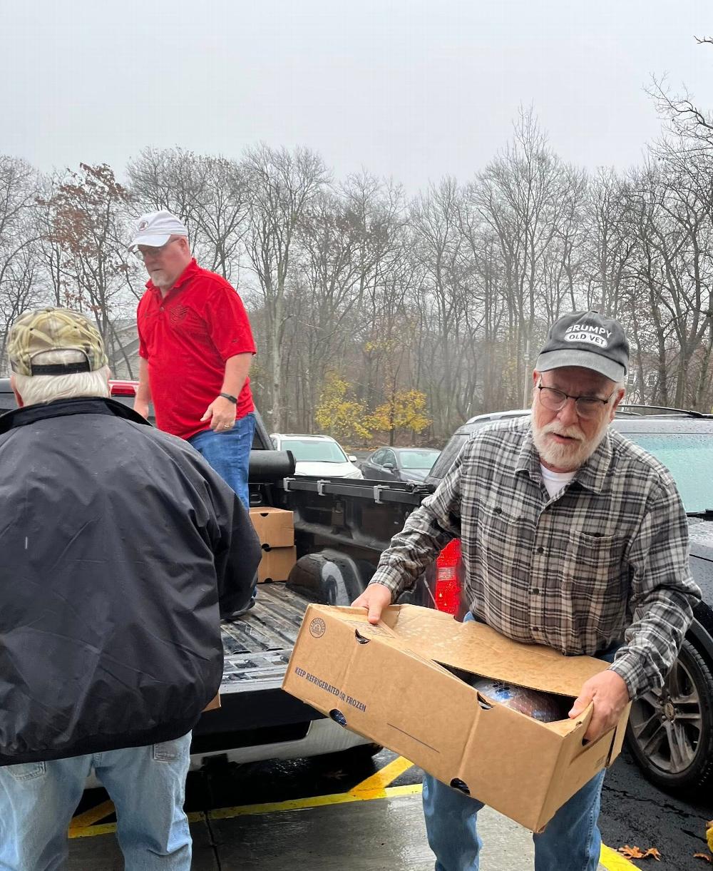 Mark Good PER Helping with Turkeys for Thanksgiving Donner Baskets 