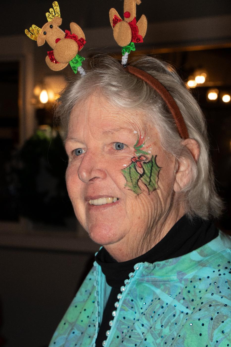 One of Santa's Helpers Barbara showing off Millie's face painting talent