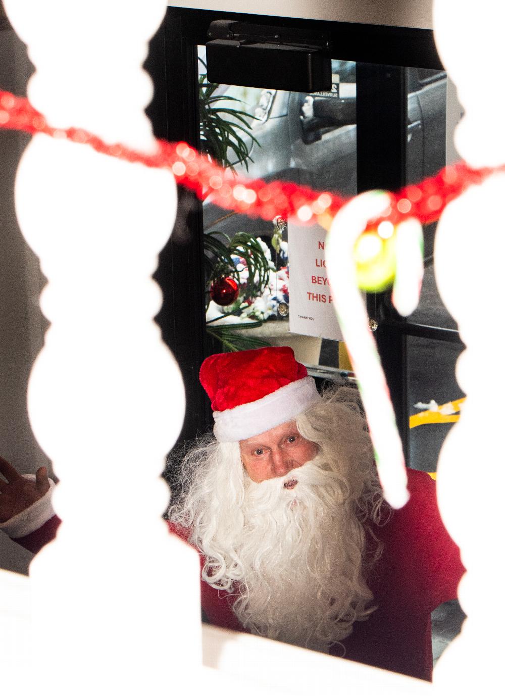 Santa sneaking in  the front door of the lodge