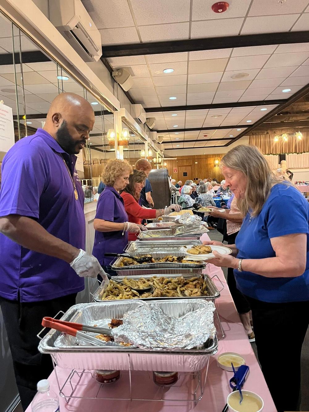 Big Shug and Denise Menz, serving to our seniors at the luncheon.