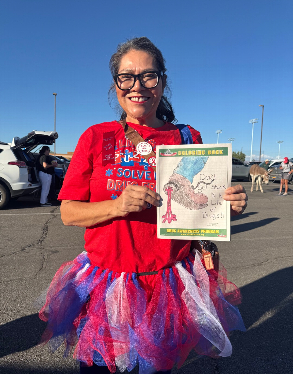 MALC Cheer Team member visits the drug awareness booth at the Walk away from drugs event. October 22nd, 2025
