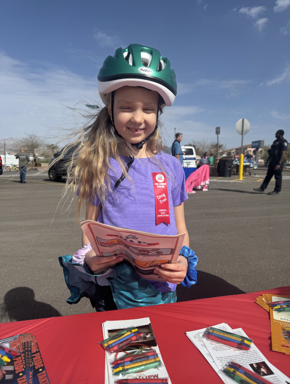 Drug Awareness booth visitor checking our her new coloring book Sarah and Karen gave her.