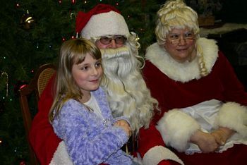 Santa & Mrs. Clause with a young guest