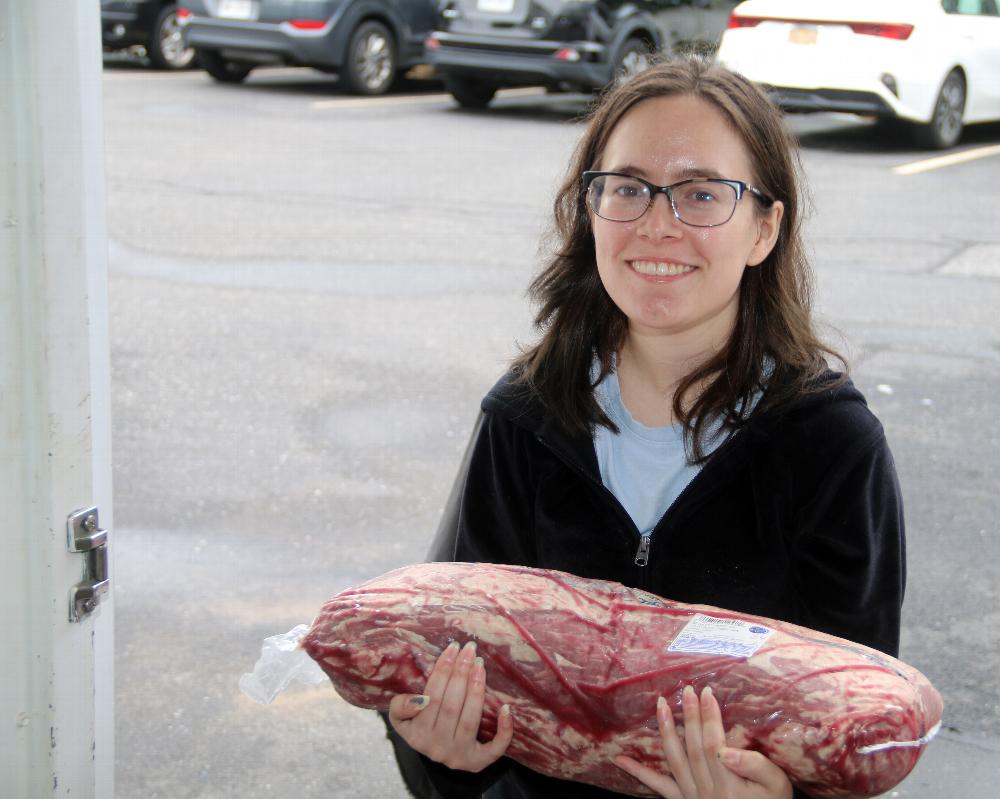  Jaci Narducci who volunteered her time bring in one of two 20 pound Ribs for a 4th of July feast at the 4 Vets beacon houses in Islip and Bay Shore.